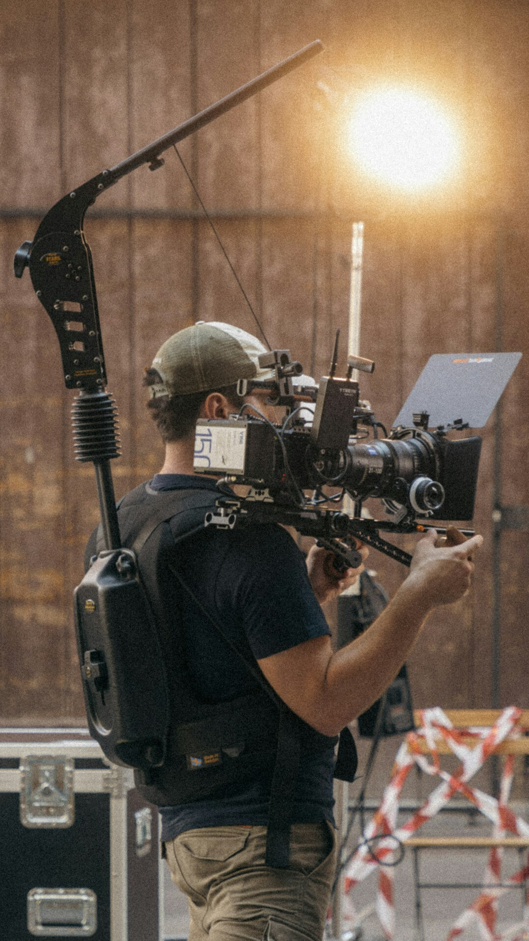 cinematographer adjusting camera settings